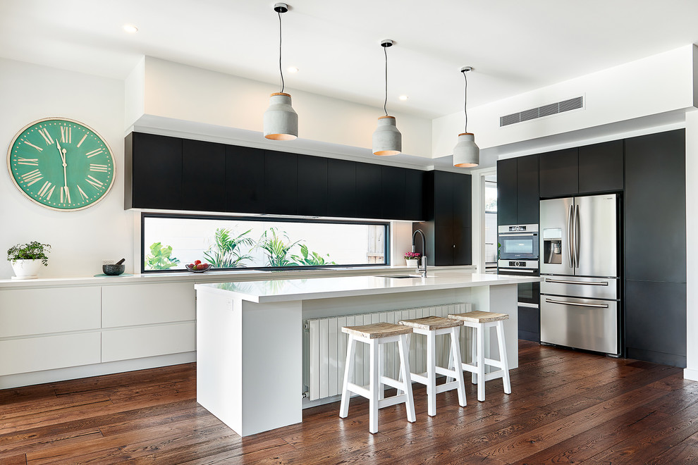 Photo of a large contemporary l-shaped open plan kitchen in Melbourne with a single-bowl sink, flat-panel cabinets, black cabinets, quartz benchtops, window splashback, stainless steel appliances, dark hardwood floors and with island.