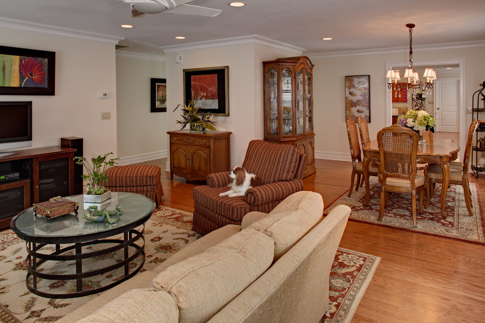 Mid-sized traditional open plan dining in Newark with beige walls, medium hardwood floors, no fireplace and brown floor.
