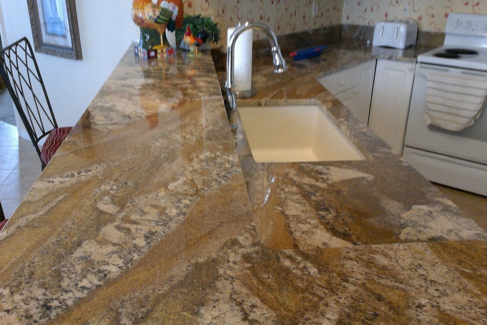 Small transitional u-shaped ceramic tile open concept kitchen photo in Miami with an undermount sink, raised-panel cabinets, white cabinets, granite countertops, multicolored backsplash, white appliances and a peninsula