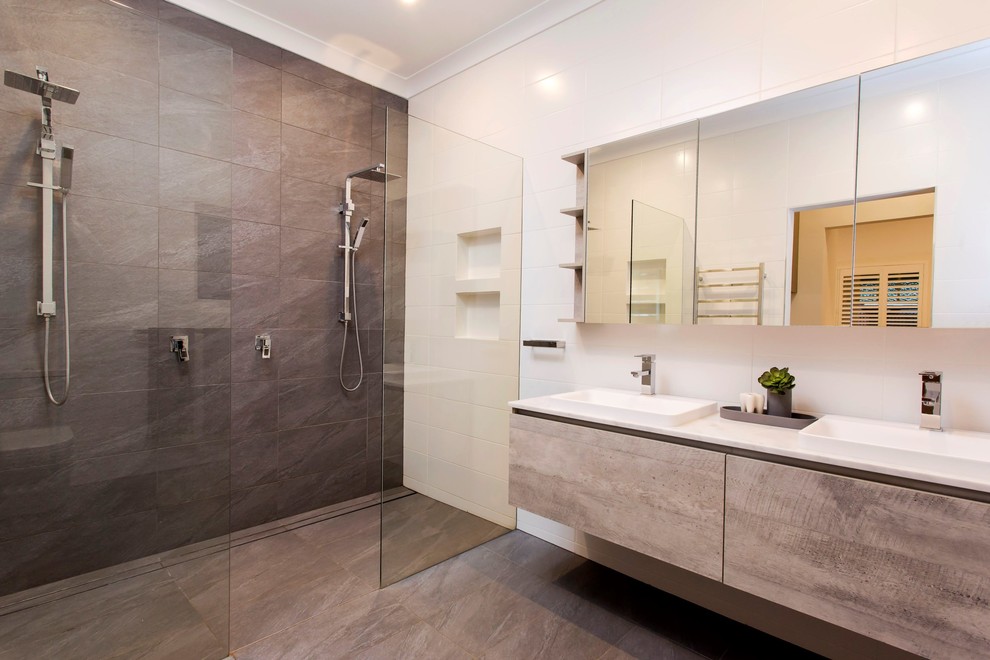 Inspiration for a large modern master bathroom in Adelaide with a double shower, gray tile, white walls, porcelain floors, grey floor, an open shower, flat-panel cabinets, distressed cabinets, porcelain tile, a drop-in sink and marble benchtops.