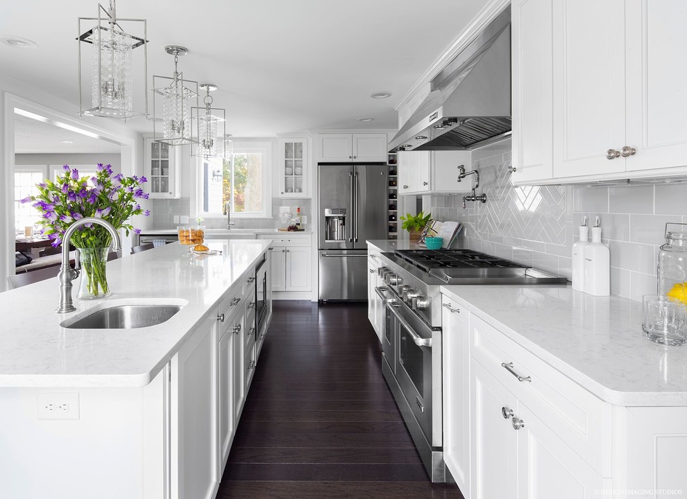 Design ideas for a traditional kitchen in Boston with an undermount sink, recessed-panel cabinets, white cabinets, grey splashback, stainless steel appliances, dark hardwood floors and with island.