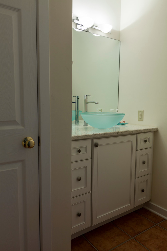 Photo of a small traditional powder room in Bridgeport with flat-panel cabinets, white cabinets, a two-piece toilet, white walls, porcelain floors, a vessel sink and recycled glass benchtops.