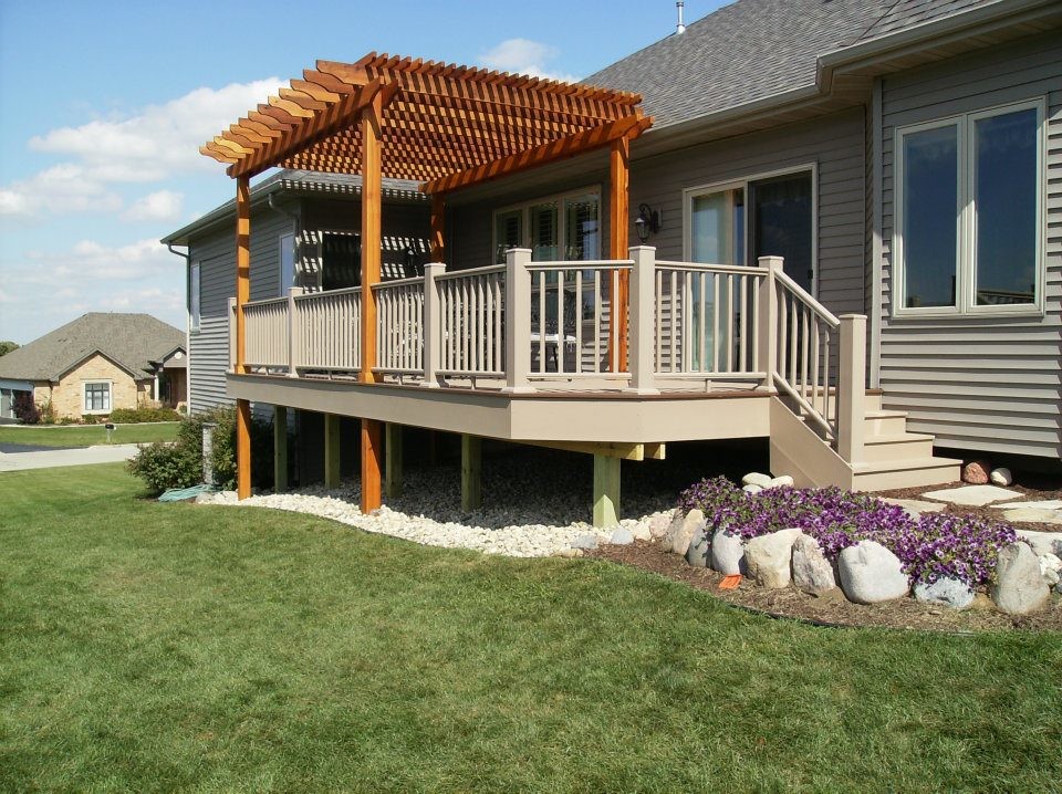 This is an example of a mid-sized backyard deck in Chicago with a pergola.
