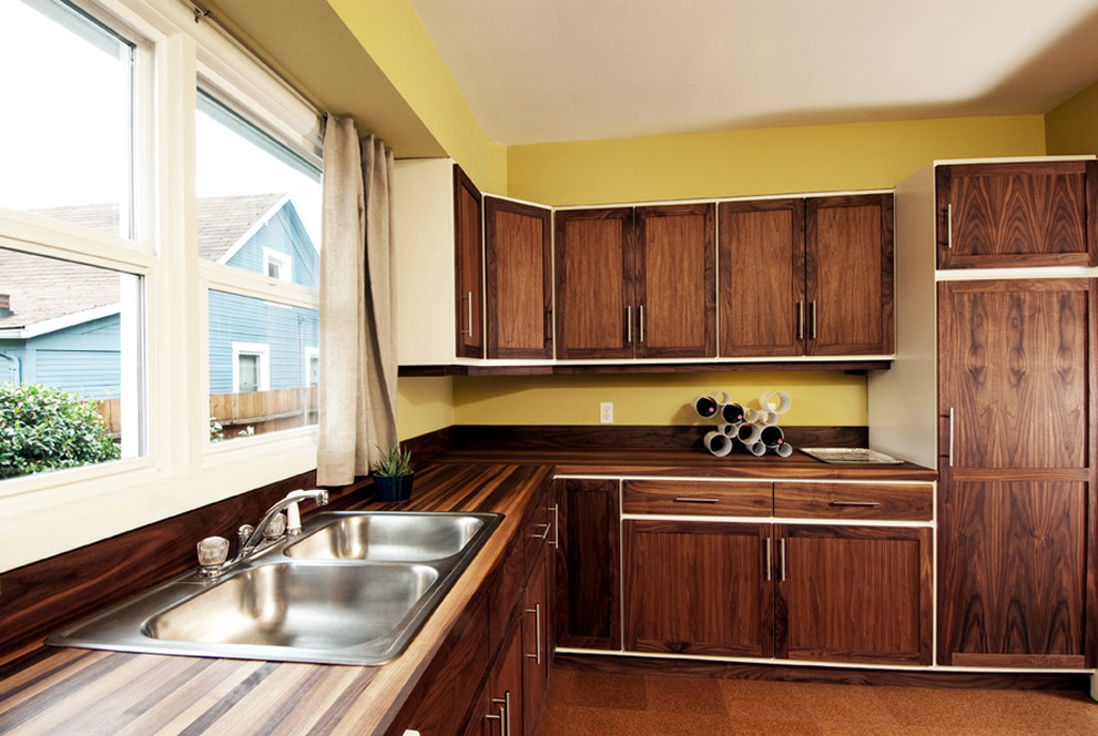 Photo of a modern kitchen in Portland with wood benchtops, a drop-in sink, shaker cabinets and dark wood cabinets.