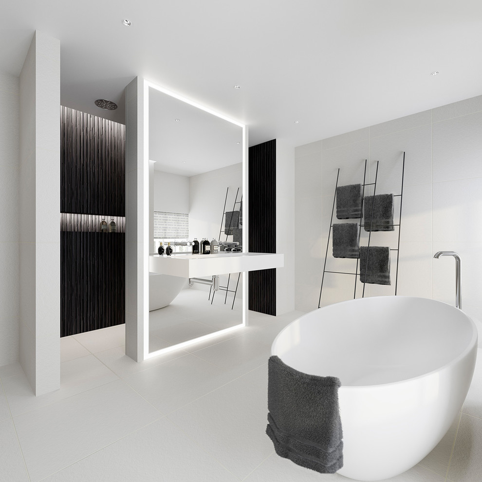 This is an example of a large modern kids wet room bathroom in London with a freestanding tub, black tile, white tile, mosaic tile, ceramic floors, a wall-mount sink, an open shower, white walls and white floor.