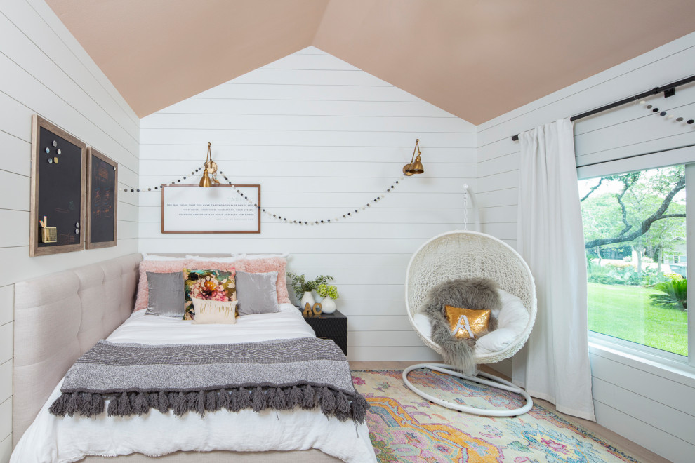 Mid-sized transitional kids' bedroom in Austin with white walls, medium hardwood floors and brown floor for kids 4-10 years old and girls.