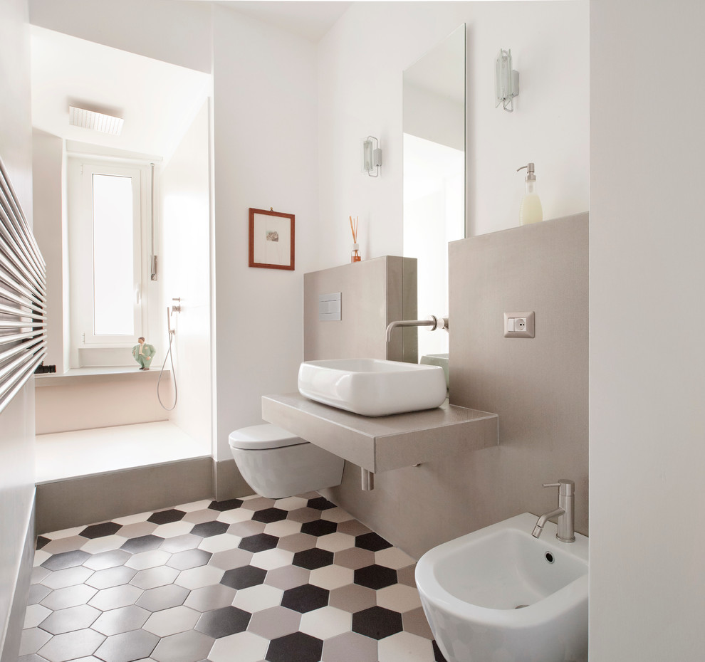 Large modern bathroom in Rome with black and white tile, an alcove shower, a vessel sink and beige walls.