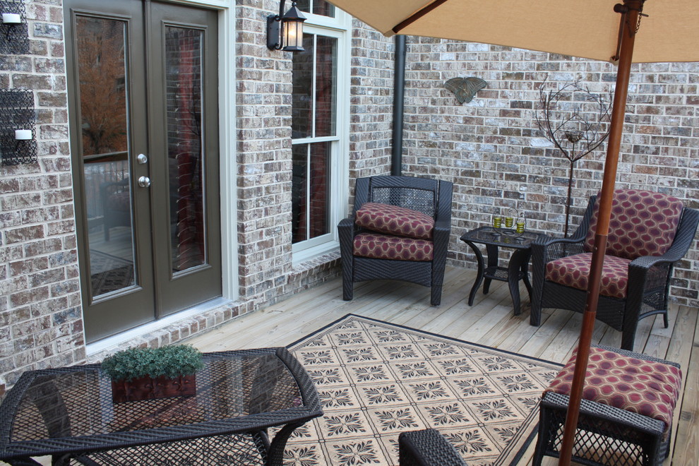Photo of a small transitional backyard patio in Atlanta with decking.