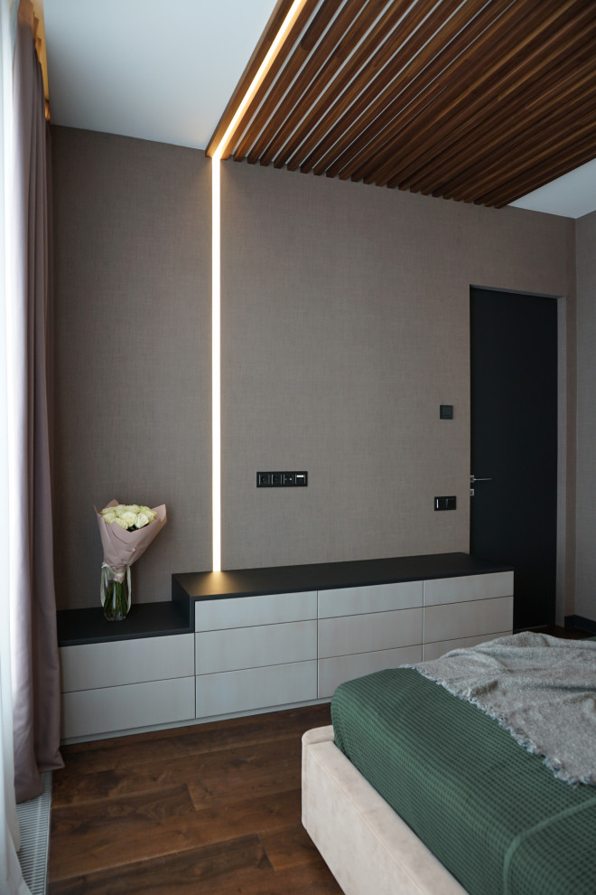 This is an example of a mid-sized contemporary master bedroom in Moscow with brown walls, medium hardwood floors, brown floor, wood and wallpaper.