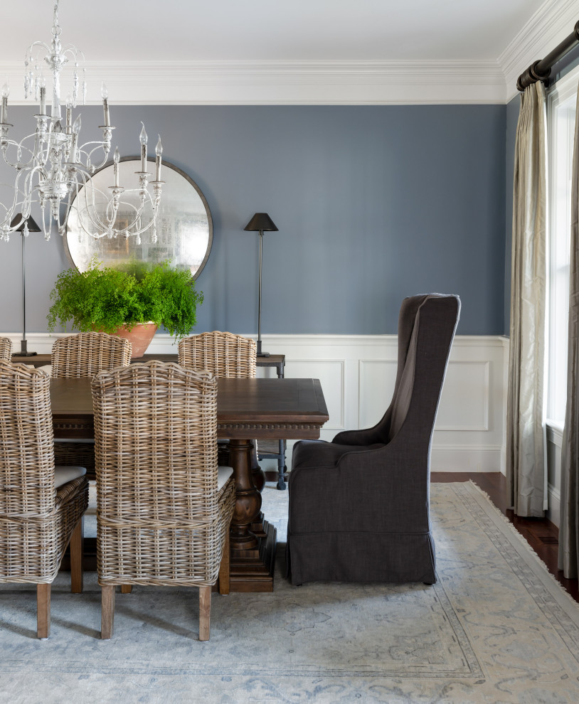 Photo of a transitional dining room in Boston with blue walls, dark hardwood floors, brown floor and decorative wall panelling.