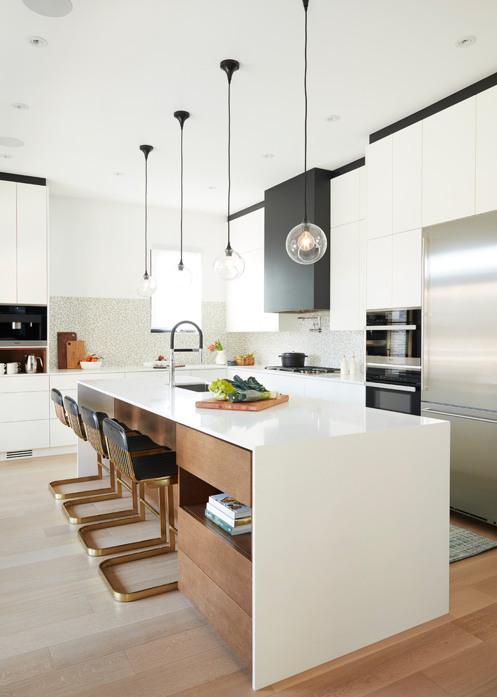 This is an example of a modern l-shaped kitchen in Toronto with an undermount sink, flat-panel cabinets, white cabinets, multi-coloured splashback, black appliances, medium hardwood floors, with island and white benchtop.