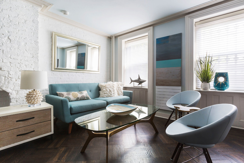 Photo of a beach style living room in New York with white walls, dark hardwood floors and brown floor.