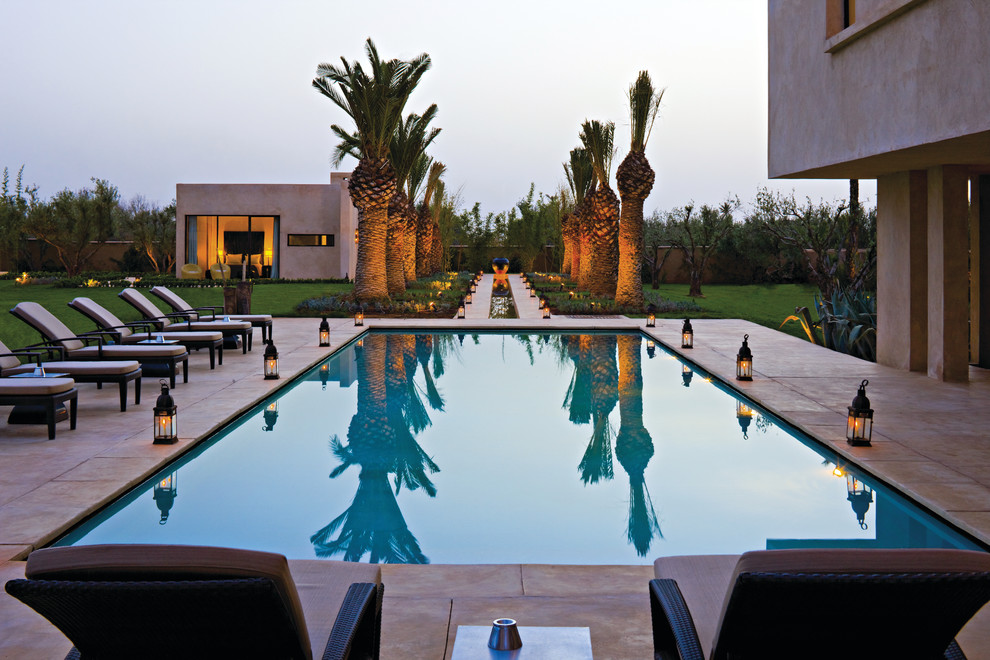 This is an example of a mid-sized mediterranean rectangular lap pool in Other with a pool house.