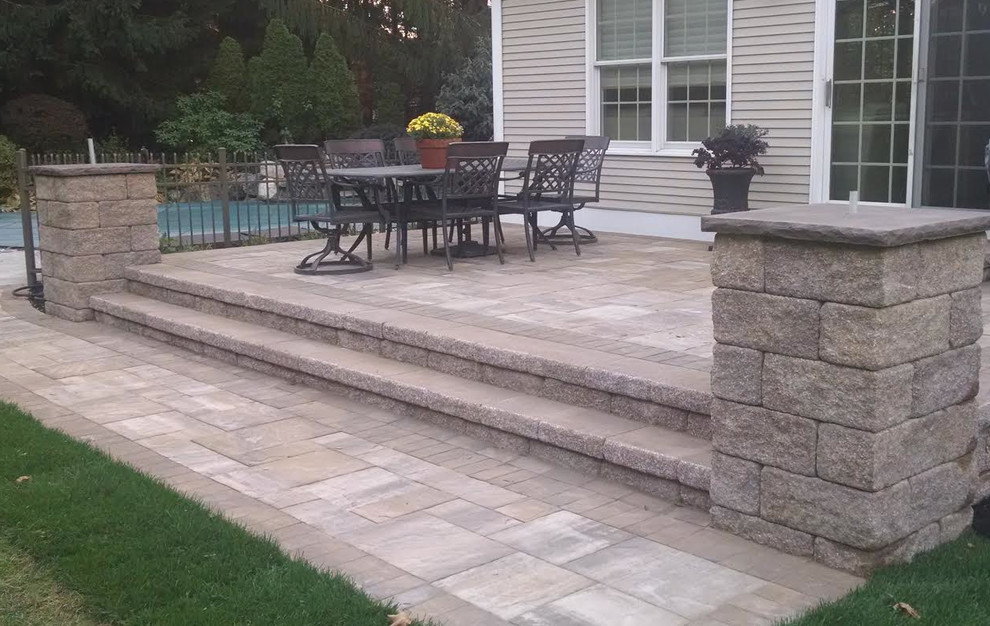 Large traditional backyard patio in New York with concrete pavers, no cover and an outdoor kitchen.