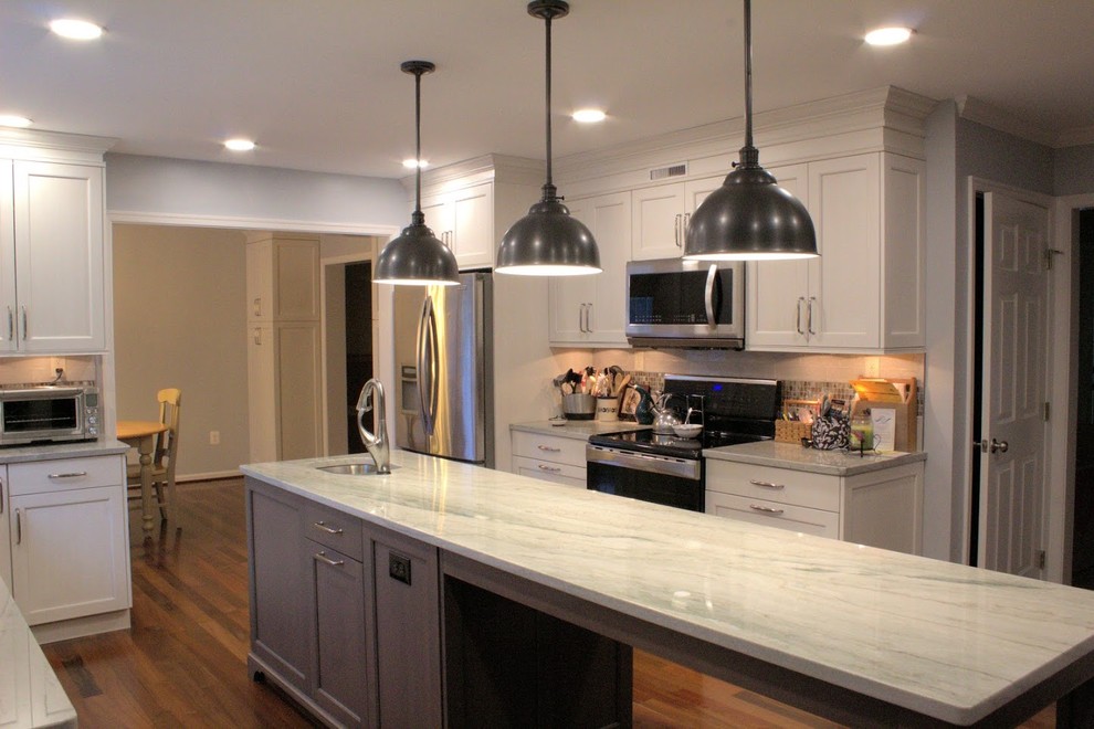 Inspiration for a large transitional galley medium tone wood floor and brown floor eat-in kitchen remodel in Baltimore with a single-bowl sink, recessed-panel cabinets, white cabinets, quartzite countertops, gray backsplash, glass tile backsplash, stainless steel appliances, an island and multicolored countertops