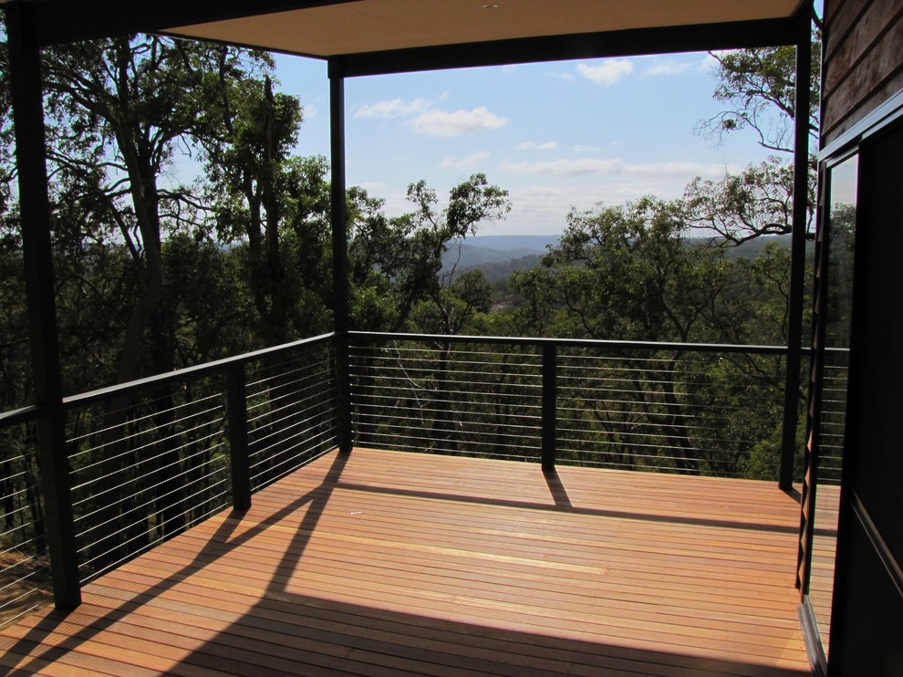 Inspiration for a mid-sized contemporary one-storey exterior in Perth with wood siding and a flat roof.
