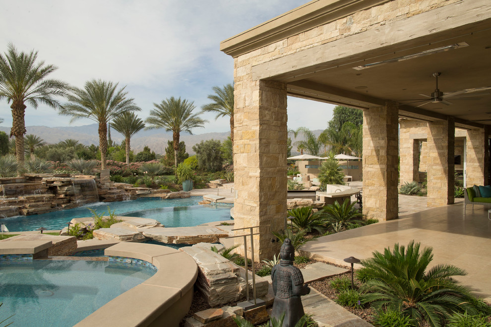 Pool fountain - mid-sized transitional backyard concrete paver and round natural pool fountain idea