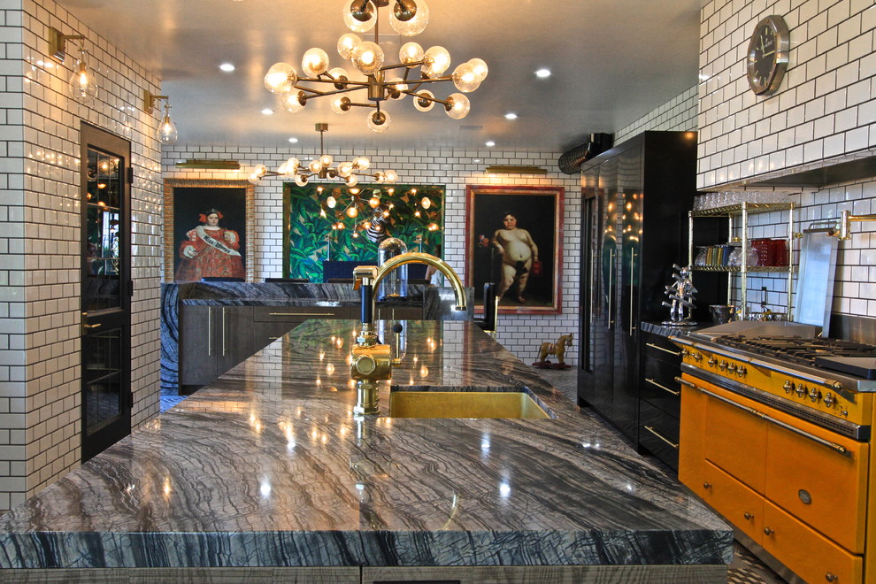 Inspiration for a huge eclectic l-shaped ceramic tile enclosed kitchen remodel in Orange County with an undermount sink, flat-panel cabinets, gray cabinets, marble countertops, white backsplash, subway tile backsplash, black appliances and an island