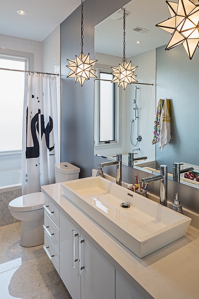 Photo of a mid-sized contemporary 3/4 bathroom in Toronto with a trough sink, flat-panel cabinets, white cabinets, a shower/bathtub combo, grey walls, an alcove tub, a two-piece toilet and a shower curtain.