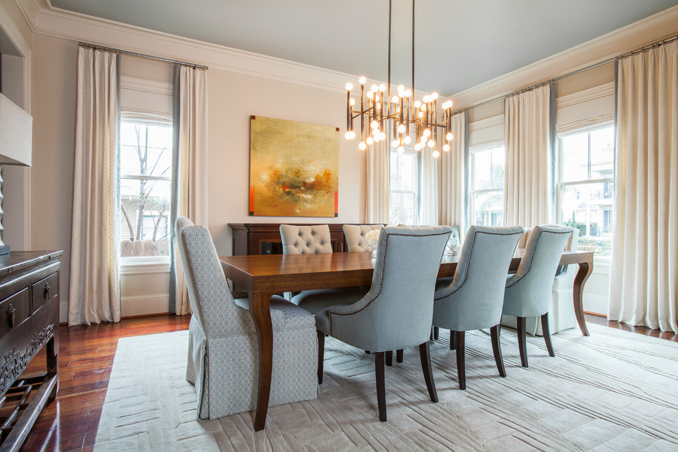 Transitional dining room with beige walls and dark hardwood floors.