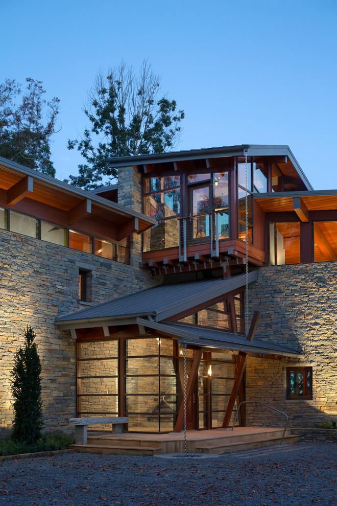 This is an example of an expansive contemporary three-storey exterior in Nashville with mixed siding.