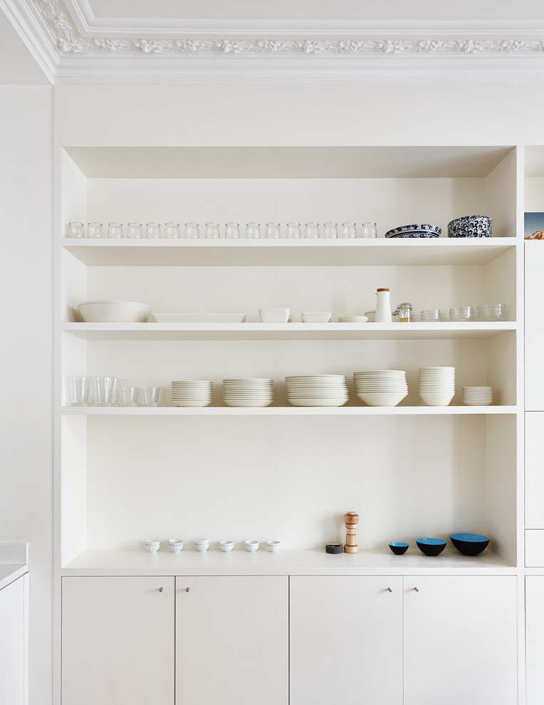 Scandinavian kitchen in Paris with flat-panel cabinets and white cabinets.