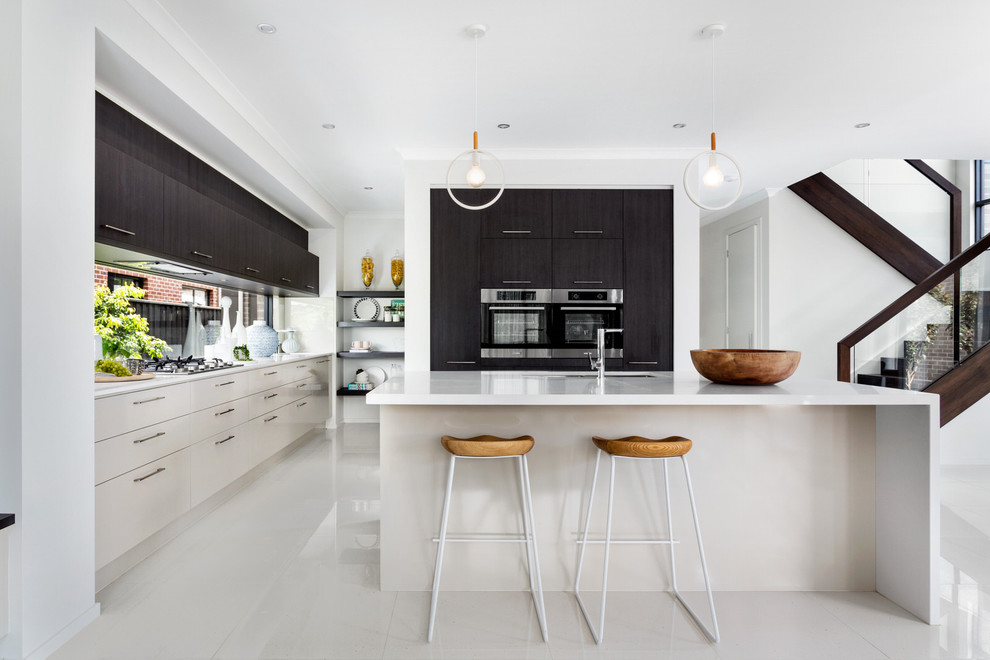 Design ideas for a contemporary l-shaped open plan kitchen in Melbourne with an undermount sink, flat-panel cabinets, window splashback, black appliances, with island and beige floor.