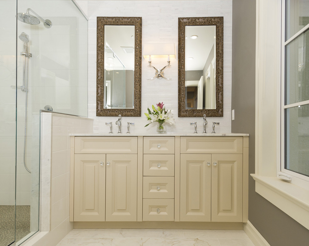 This is an example of a mid-sized traditional 3/4 bathroom in Vancouver with raised-panel cabinets, beige cabinets, a corner shower, white tile, mosaic tile, brown walls, mosaic tile floors, an undermount sink and marble benchtops.