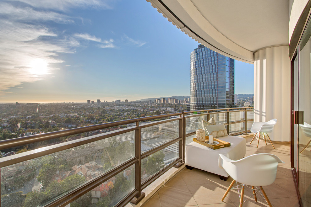 Example of a small trendy balcony design in Los Angeles with a roof extension