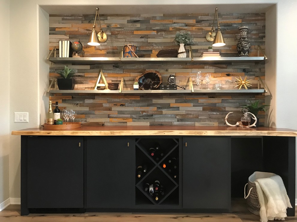 Small transitional single-wall bar cart in Los Angeles with no sink, flat-panel cabinets, black cabinets, wood benchtops, multi-coloured splashback, timber splashback, light hardwood floors and brown floor.