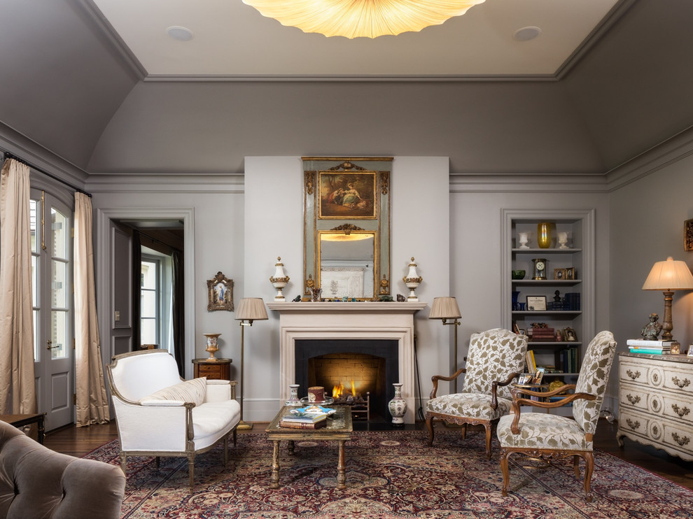 This is an example of a mid-sized traditional formal enclosed living room in Birmingham with grey walls, dark hardwood floors, a standard fireplace, a stone fireplace surround and no tv.