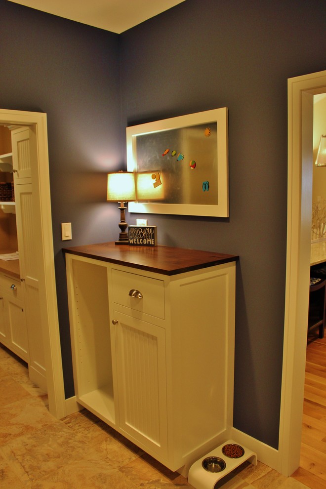 This is an example of a beach style mudroom in Grand Rapids with blue walls and ceramic floors.