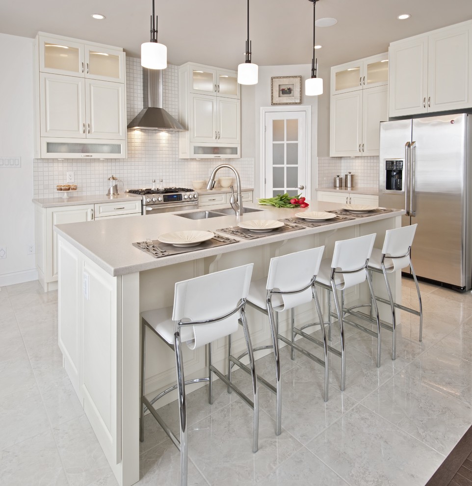 Inspiration for a transitional l-shaped kitchen in Ottawa with an undermount sink, flat-panel cabinets, white cabinets, stainless steel appliances, with island, white floor, white splashback, mosaic tile splashback and porcelain floors.