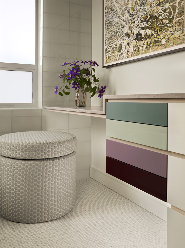 Inspiration for a mid-sized contemporary bathroom in San Francisco with flat-panel cabinets, white cabinets, a one-piece toilet, gray tile, mosaic tile, white walls, mosaic tile floors, an undermount sink and granite benchtops.