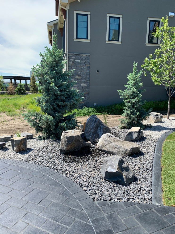 Photo of a large beach style backyard full sun xeriscape in Calgary with with rock feature and decomposed granite.