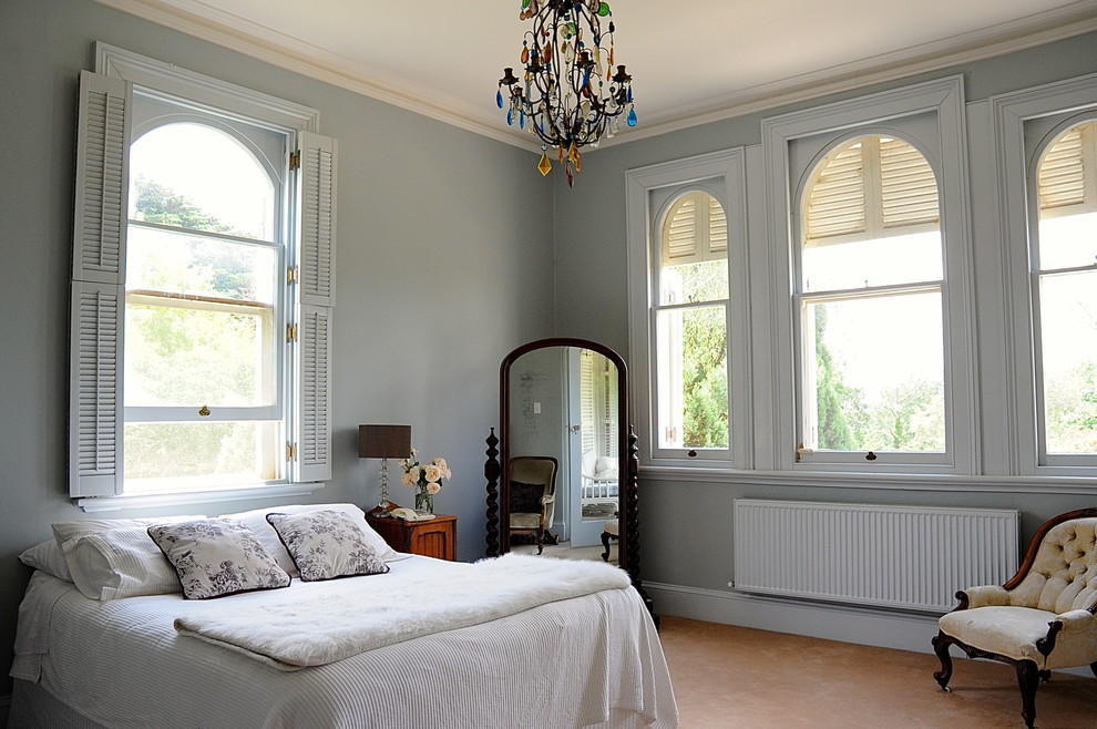 This is an example of a traditional bedroom in Sydney with grey walls.