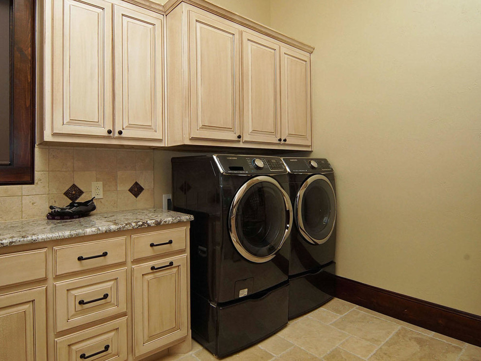 Large mediterranean u-shaped utility room in Dallas with raised-panel cabinets, granite benchtops, beige walls, ceramic floors, a side-by-side washer and dryer and light wood cabinets.