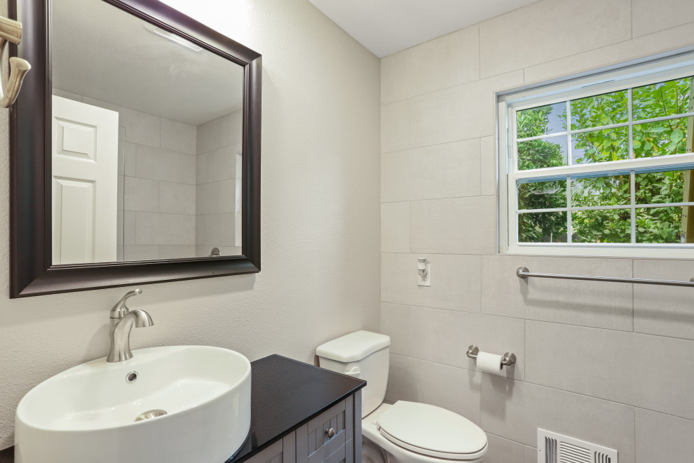 This is an example of a contemporary bathroom in Sacramento with grey cabinets, white walls, a vessel sink, a hinged shower door and a single vanity.