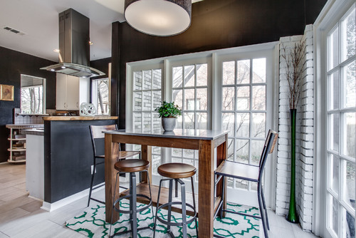 Mix and matching two different styles of stools with a rectangular pub table next to a window