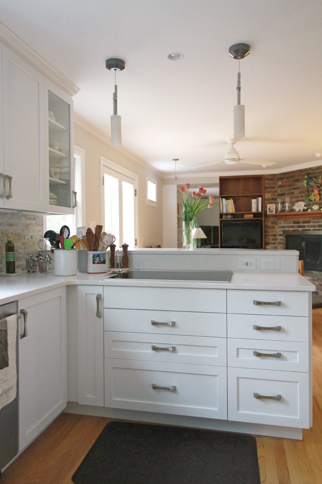 Mid-sized transitional u-shaped eat-in kitchen photo with flat-panel cabinets, white cabinets and a peninsula