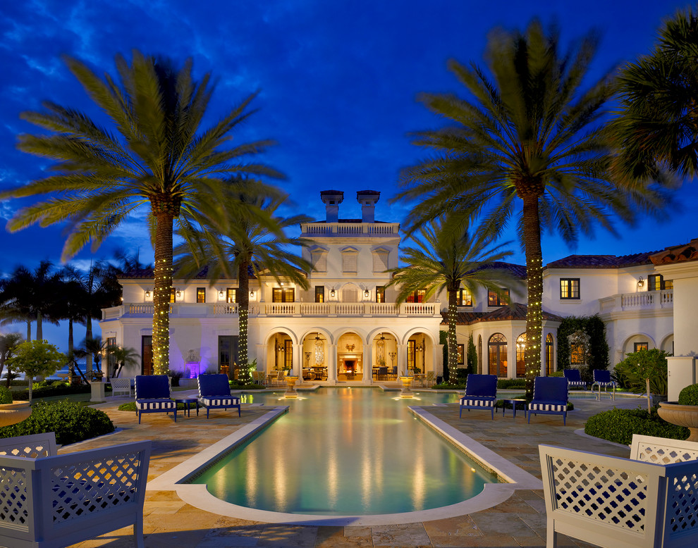 This is an example of an expansive mediterranean two-storey white exterior in Miami.