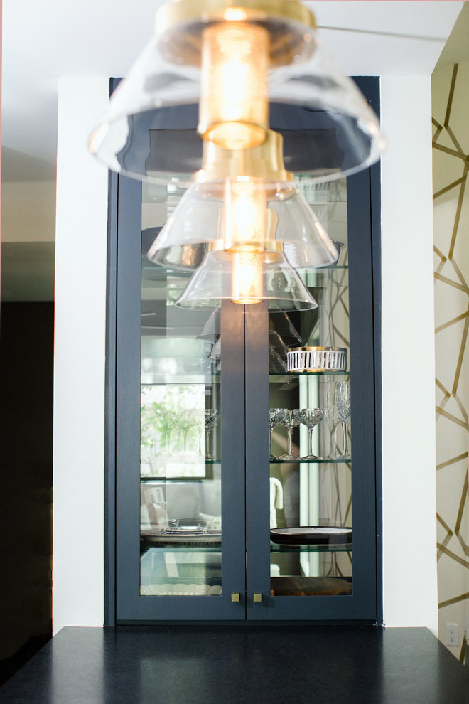 Eat-in kitchen - mid-sized transitional l-shaped cement tile floor and gray floor eat-in kitchen idea in Austin with an undermount sink, flat-panel cabinets, blue cabinets, quartz countertops, white backsplash, stainless steel appliances, an island and black countertops