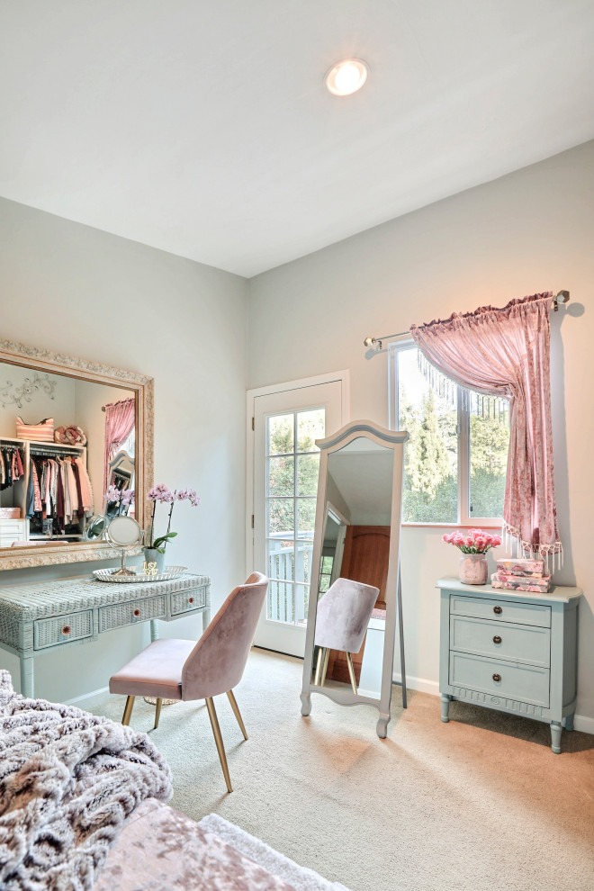 This is an example of a mid-sized traditional women's dressing room with shaker cabinets, white cabinets, carpet and beige floor.