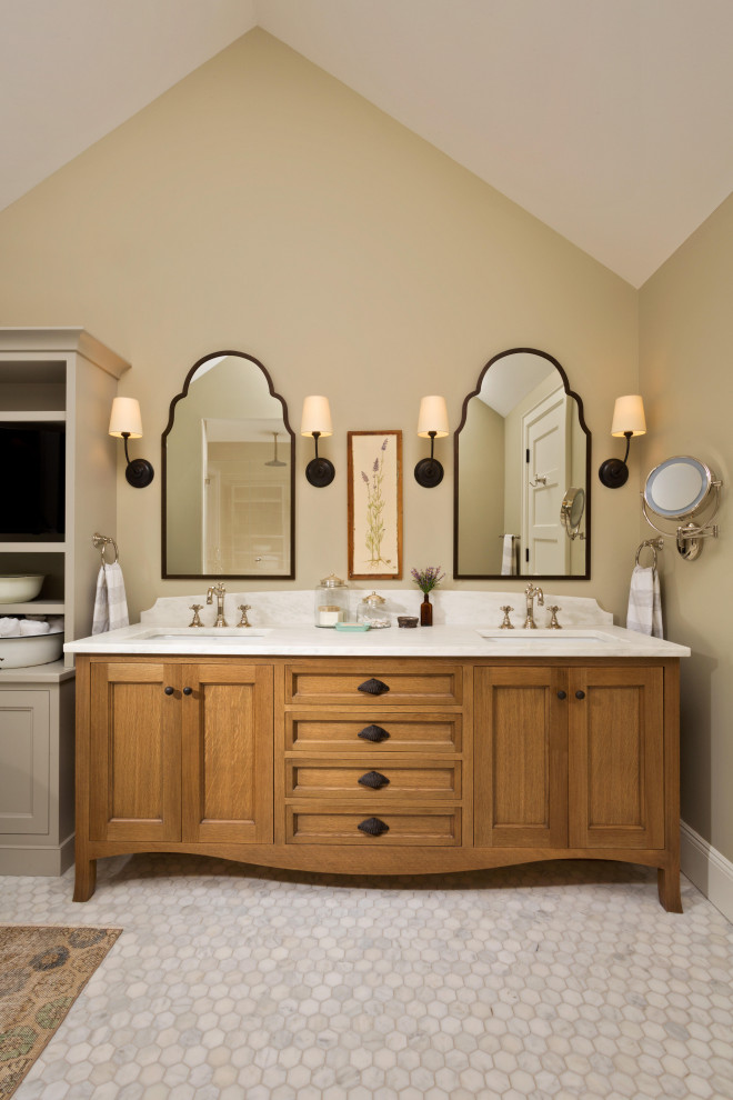 This is an example of a large traditional master bathroom in New York with brown cabinets, a freestanding tub, white tile, ceramic tile, beige walls, porcelain floors, an undermount sink, white floor, a hinged shower door, white benchtops, a shower seat, a double vanity, a floating vanity, vaulted and recessed-panel cabinets.