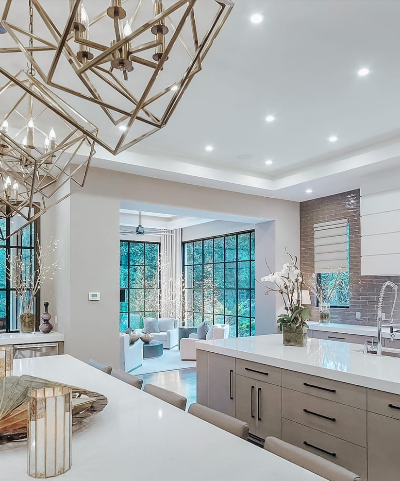 Mid-sized u-shaped eat-in kitchen in Dallas with ceramic splashback, stainless steel appliances, ceramic floors, multiple islands, white floor, white benchtop, recessed, flat-panel cabinets, quartz benchtops, an undermount sink, beige cabinets and beige splashback.
