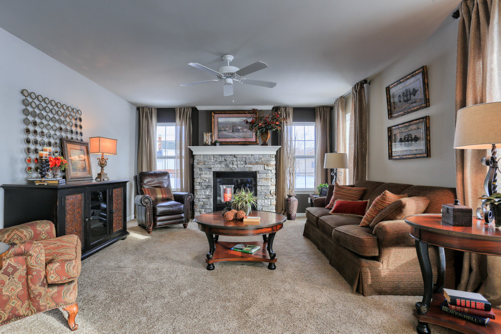 Inspiration for a mid-sized rustic open concept carpeted home design remodel with gray walls, a standard fireplace and a stone fireplace