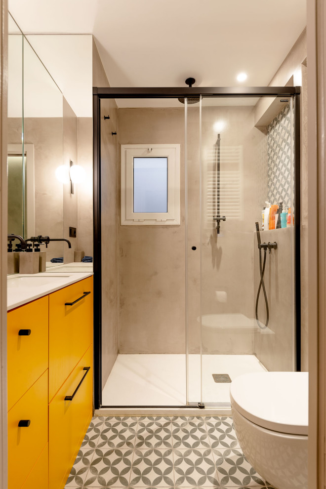 This is an example of a small contemporary master bathroom in Barcelona with flat-panel cabinets, white cabinets, a curbless shower, a one-piece toilet, gray tile, ceramic tile, grey walls, ceramic floors, an undermount sink, engineered quartz benchtops, grey floor, a sliding shower screen, white benchtops, a single vanity and a built-in vanity.