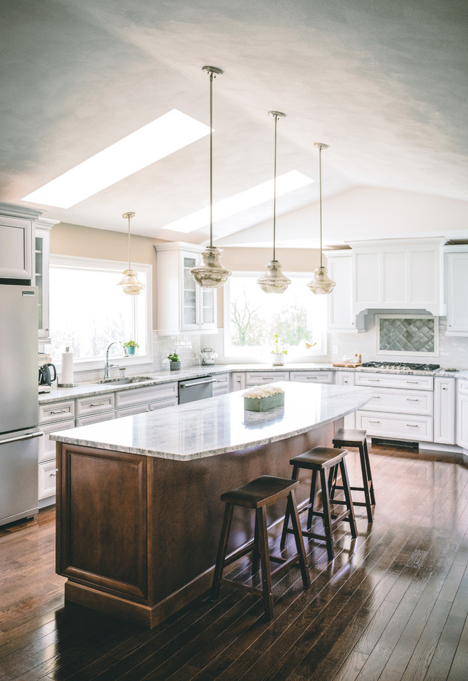 Eat-in kitchen - transitional u-shaped brown floor and dark wood floor eat-in kitchen idea in New York with an undermount sink, recessed-panel cabinets, white cabinets, granite countertops, multicolored backsplash, glass tile backsplash, stainless steel appliances, an island and multicolored countertops
