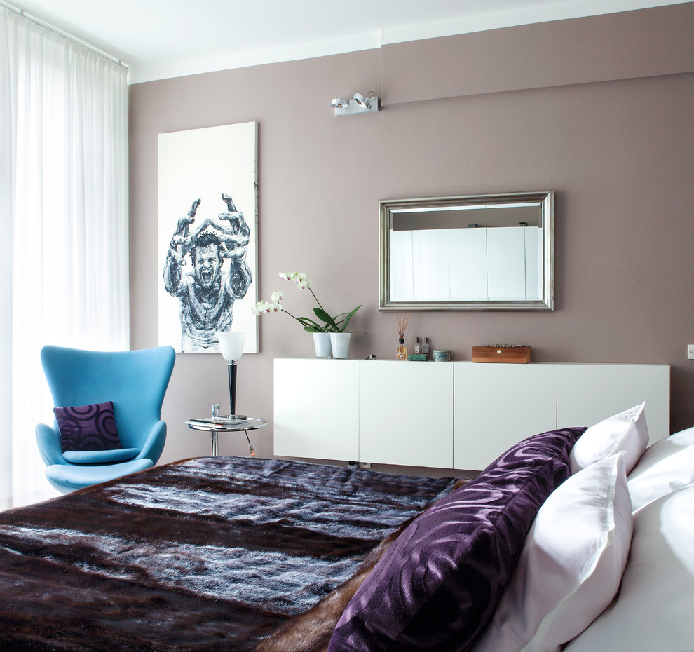 Ejemplo de dormitorio principal contemporáneo de tamaño medio sin chimenea con suelo de madera en tonos medios y paredes grises