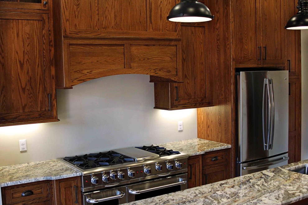 Inspiration for a rustic kitchen remodel with dark wood cabinets, granite countertops and an island
